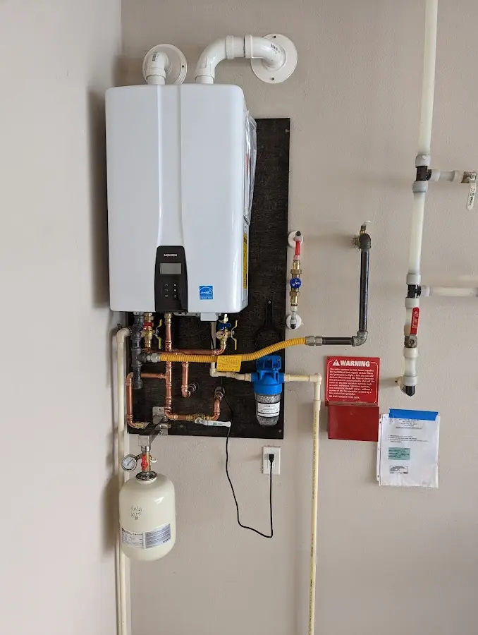 Professional plumber installing copper piping in a Woodstock home